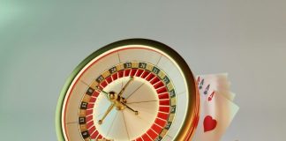 A clock, dice, and casino chips on a table