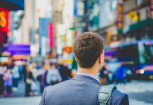 shallow focus photography of man in suit jacket's back