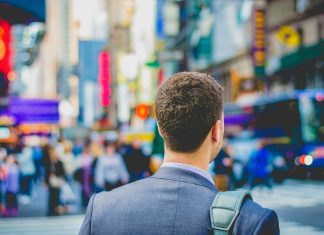 shallow focus photography of man in suit jacket's back