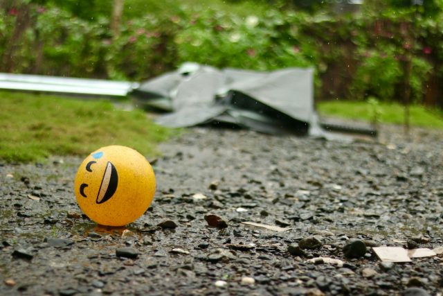 Photo by Eduardo Jr. Lopez A smiley face ball sitting on a gravel road