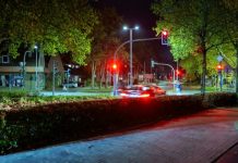 Car driving through a street at night