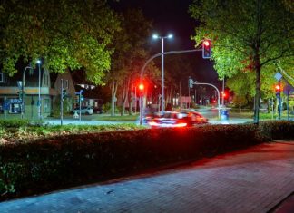 Car driving through a street at night