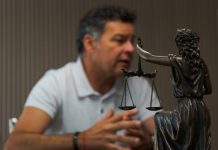 The Essential Role of an Initial Legal Consultation in Accident Claims A man sitting at a table in front of a statue