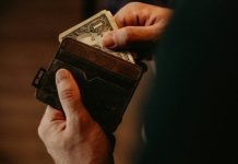 Practicing Mindful Spending person getting 1 U.S. dollar banknote in wallet