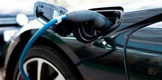 an electric car plugged in to a charger