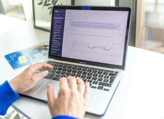 a person using a laptop computer on a desk