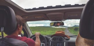 man driving straight on pathway during day time