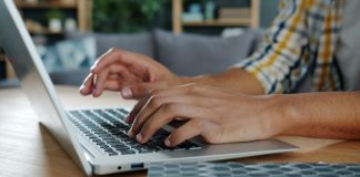Person typing on a laptop computer at a desk