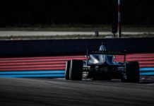 red and black f 1 race car on track during daytime