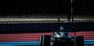 red and black f 1 race car on track during daytime