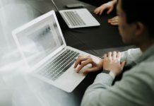 a man sitting in front of a laptop computer