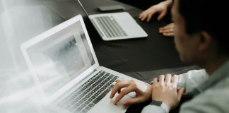 a man sitting in front of a laptop computer