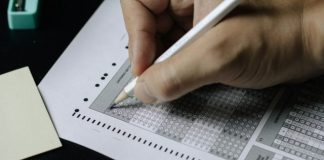 person writing on white paper