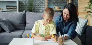 Mother and son drawing together at a table.