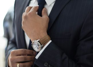 man wearing watch with black suit