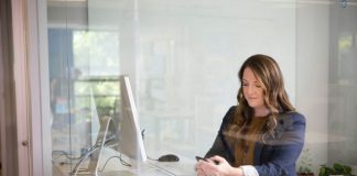 woman in black leather jacket using macbook air