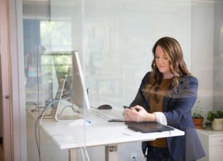 woman in black leather jacket using macbook air