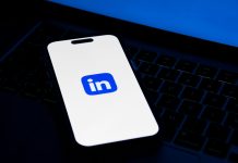 a phone sitting on top of a laptop computer