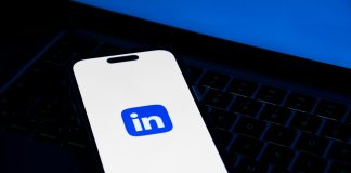 a phone sitting on top of a laptop computer