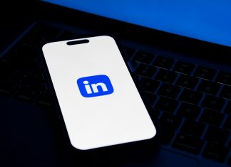 a phone sitting on top of a laptop computer