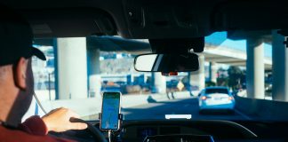 person holding iphone 6 inside car