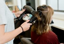 How Hairstyle AI Helps You Avoid Haircut Regret woman in red long sleeve shirt holding hair blower
