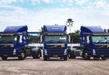 a couple of blue trucks parked next to each other