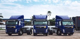 a couple of blue trucks parked next to each other