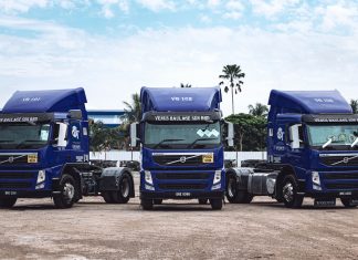 a couple of blue trucks parked next to each other