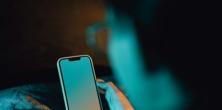 A person holding a cell phone in their hand