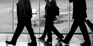 man in black pants and black jacket walking on ice covered ground