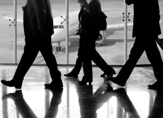 man in black pants and black jacket walking on ice covered ground