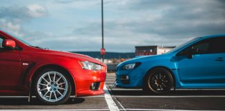 blue and red cars in parking lots