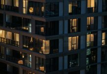 Modern building with illuminated windows at night.