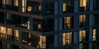 Modern building with illuminated windows at night.