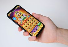 A hand holds a phone with an egyptian-themed game.