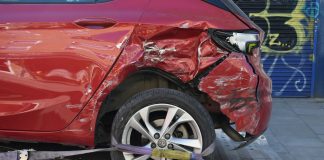 a red car is on a flatbed tow truck