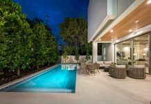 Modern home with pool and outdoor seating area.