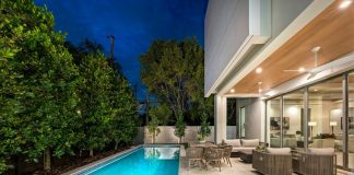 Modern home with pool and outdoor seating area.