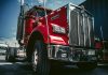red and white truck on black asphalt road