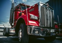 red and white truck on black asphalt road