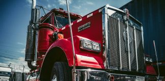 red and white truck on black asphalt road