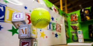 yellow and red baseball on white table