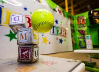 yellow and red baseball on white table
