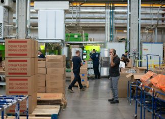Simple Warehouse Management Tips for Beginners man in gray shirt standing beside brown cardboard boxes