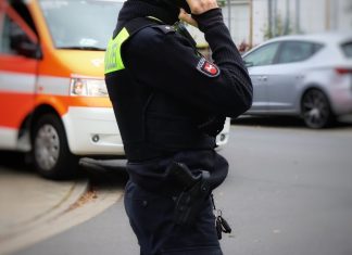 a police officer talking on a cell phone
