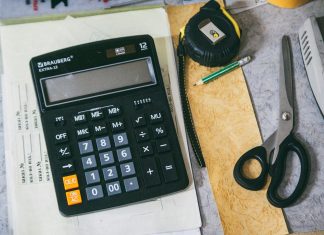 Calculator and office supplies on a desk.
