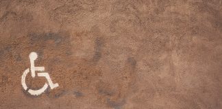 a handicap sign painted on the side of a wall