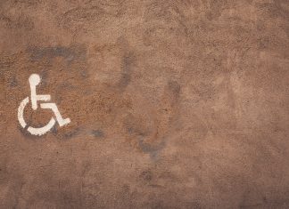 a handicap sign painted on the side of a wall