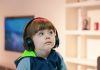 boy near white wooden shelf